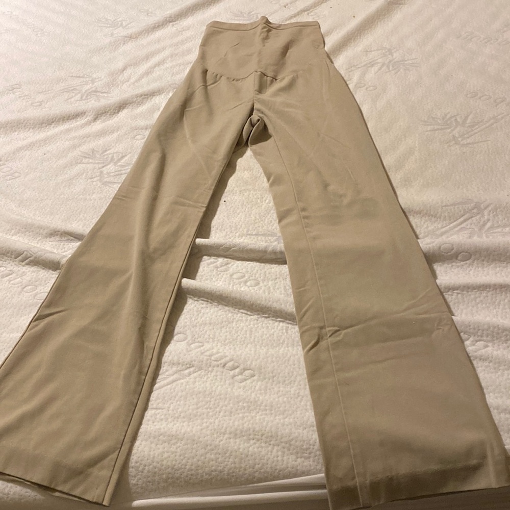 Women’s maternity tan dress pants with high belly band.